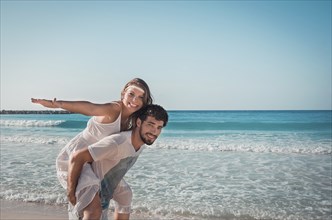 Couple of lovers embracing on caribbean sea beach