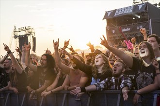 Festival-goers in the front row give the devil's salute at the Wacken Open Air in Wacken. The