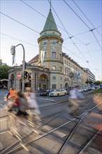 Cyclists crossing the traffic light at green at Stiglmaierplatz, motion blur, Löwenbräukeller of