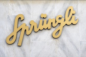 Company logo, advertising sign of the chocolate manufacturer Confiserie Sprüngli AG on a house