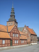 Old half-timbered building from the 18th century with St. Mary's Church from the 13th century in