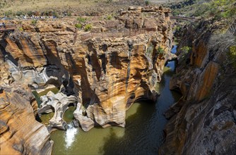 Bridge over a canyon with steep orange-coloured cliffs and the Blyde River, Bourke's Luck Potholes,