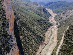 Close-up of a winding river meandering through a rocky and green landscape, aerial view, Congost de