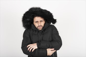 Man wearing black coat with very cold expression