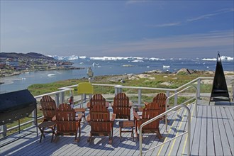 Terrace with chairs and view of the sea with icebergs, clear view and blue sky, Tourismu, Hotel,