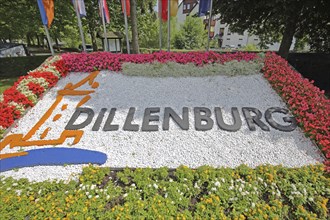 Colourful flower bed with flags, floral decoration and inscription, Dillenburg, Hesse, Germany,