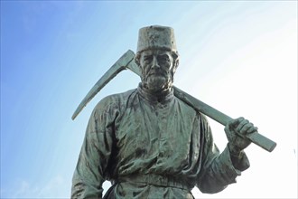 Miner Henner with pickaxe by Friedrich Reusch, 1902, symbol for miner in mining, mine, worker,