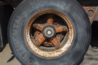 Close-up of Continental HSL tire with rusted metal rim on transportation truck, Quebec, Canada,