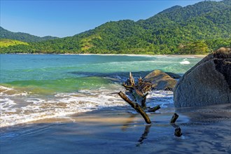 Remote beach called Bonete on the island of Ilhabela surrounded by mountains and forests and