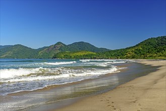 Panoramic image of Bonete beach in Ilhabela with the sea, hills and forests surrounding it, Bonete