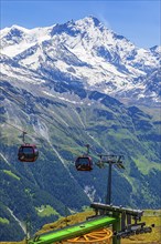 Gondolas of the cable car from Zinal to Corne de Sorebois, behind the snow-covered Weisshorn, Val