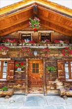 Old wooden house with floral decorations, historic village centre, Grimentz, Val d'Anniviers,