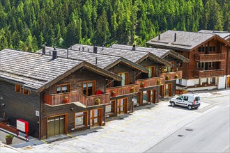 Parked car in front of wooden terraced houses, historic village centre, Grimentz, Val d'Anniviers,