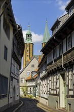 Artful half-timbered houses in the old town with a view of the Goslar Market Church of St Cosmas