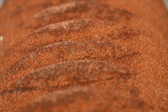 Grunge background of rusted plough shares on an old cultivator