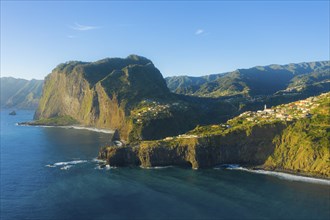 Penha d'Aguia Mountain, Faial Town and Atlantic Ocean in the Morning. Aerial View. Madeira,