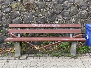 Vandalism, wilfully destroyed park bench, wooden bench, on a footpath, Duisburg, North