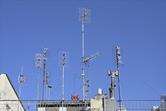 Various antennas on the roof of a residential apartment building, installation for communication