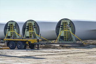 Wind turbine blades are stored near the construction site, heavy industry in preparation for a