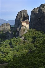 Monastery of St. Nicholas Anapausas situated at the top of a cliff in the rocky Meteora landscape