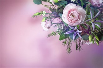 Bouquet with rose and blue flowers in the corner of a pink background, greeting card for holidays