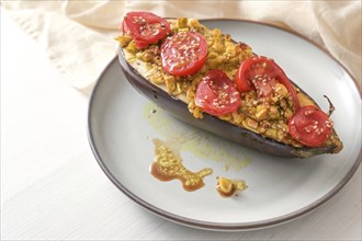 Healthy vegetarian low carb meal, baked eggplant with turmeric, ginger, onions, tomatoes and sesame