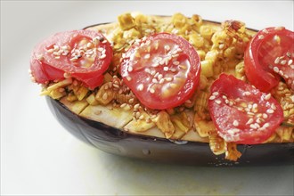 Eggplant from the oven with spaces, onions, tomatoes and sesame seed, healthy vegetarian low carb