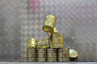 Falling tin can pyramid hit by a ball, throwing game at a carnival funfair or Christmas market,