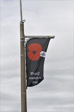 WESTPORT, NEW ZEALAND, NOVEMBER 14, 2020: An Anzac day themed flag adorns a light post in the main