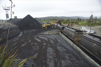 STILLWATER, NEW ZEALAND, OCTOBER 25, 2019: A payloader fills train wagons with coal at the siding