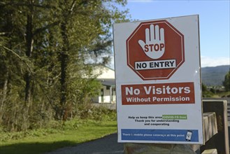 Signage shows that an essential business has restricted access during the Covid 19 lockdown in New