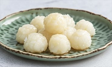 Korean honey rice cakes (yakgwa) on a pastel green plate AI generated