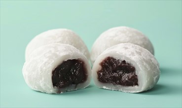 Japanese mochi with sweet red bean paste on a light green background AI generated