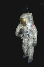 American astronaut in pressure space suit on black background