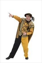 An actor in a court jester's costume poses berfore a white background