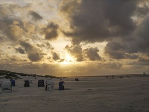 Evening mood on the beach with clouds and golden sunset, juist, east frisia, germany