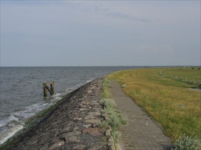 A coastal path of stones along the sea with a wide sky, Hallig Hooge, schleswig-holstein, germany