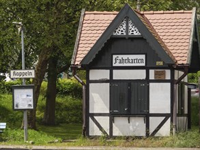 Small half-timbered building with signs and ticket office at an old railway station, Kappeln,