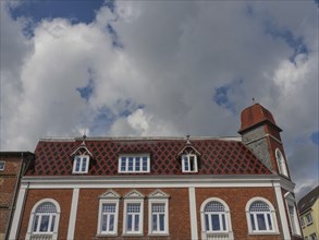 Historic building with red roof tiles under a cloudy sky, Kappeln, SChleswig-Holstein, Germany,