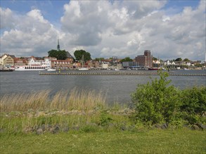 View of the town on the water with green areas and clouds, Kappeln, SChleswig-Holstein, Germany,