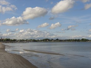 Spacious, quiet beach with shallow water and a peaceful sky with scattered clouds, Eckernförde,