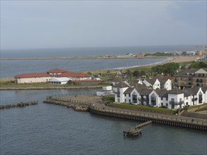 Stretch of coastline with several modern houses and views of the tranquil seascape, Newcastle,