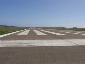 Airport runway with clear, sunny sky and horizon in the background, Lerwick, Shetlands, Scotland,