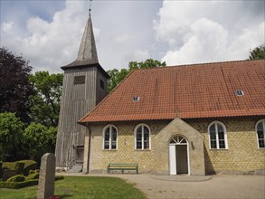 Historic church with a high tower and a red tiled roof against a sky, Arnis, Schleswig-Holstein,