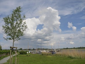 View of a harbour full of sailing boats under a sky with dense clouds, Arnis, Schleswig-Holstein,