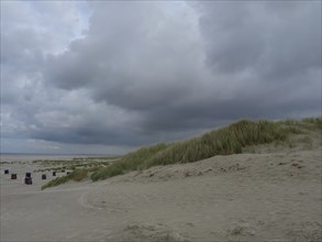 Extensive dune landscape under a cloudy sky on the beach, juist, east frisia, Germany, Europe