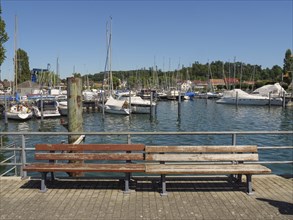 A harbour full of sailing boats and yachts moored at the jetty, under a clear sky, Meersburg, Lake