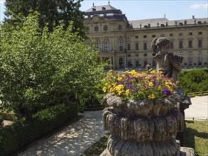 An impressive castle in the background with a splendour of flowers in the foreground, decorated