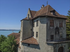 Castle overlooks a lake and is surrounded by trees, with historical details, Meersburg, Germany,