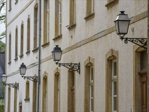 Row of old street lamps on a building façade with many windows, Luxembourg City, Luxembourg, Europe